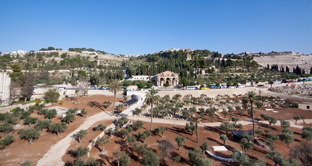 at the foot of the mountain, adjacent to the church of all